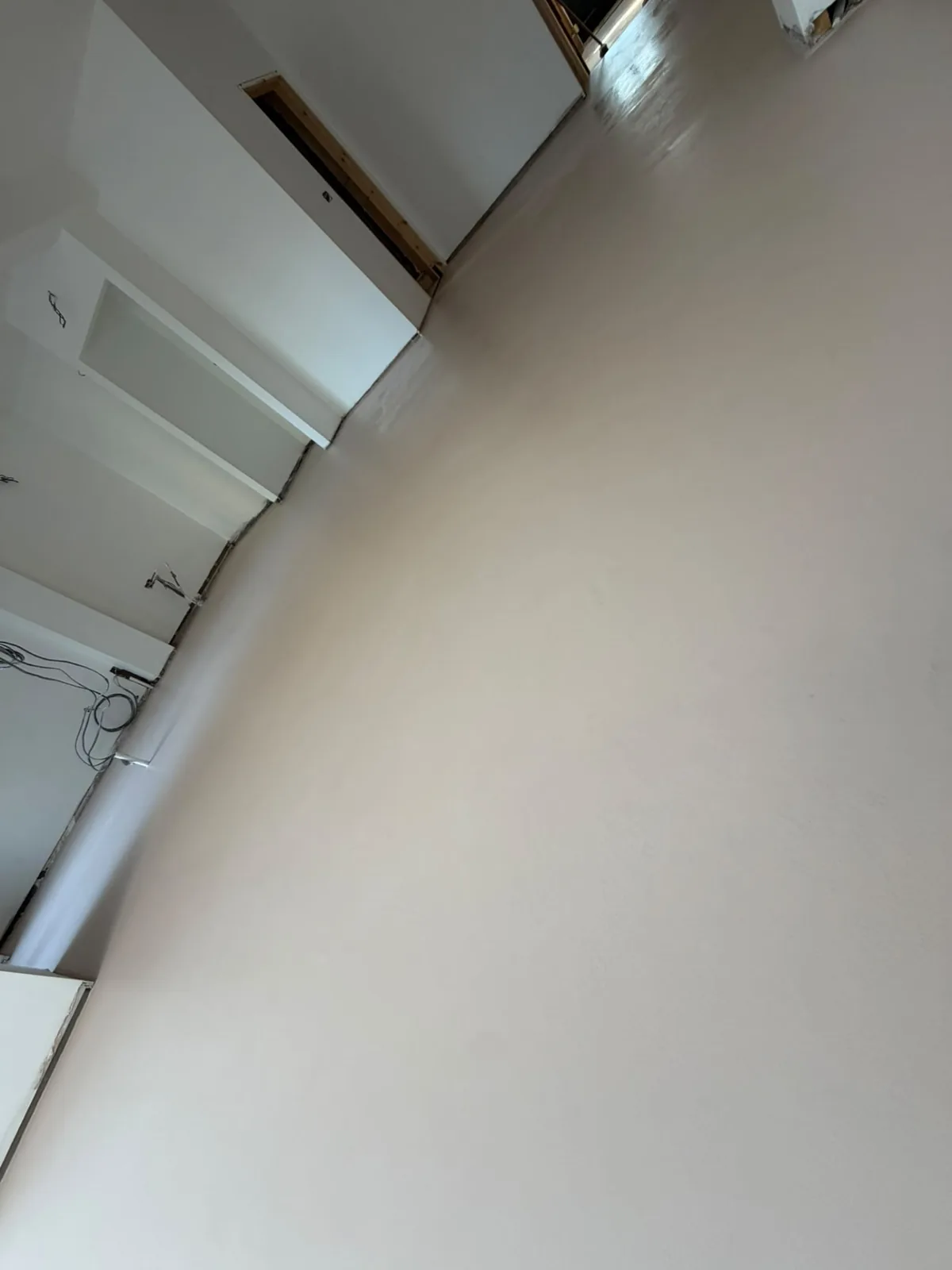 White microcement floor part-way through installation