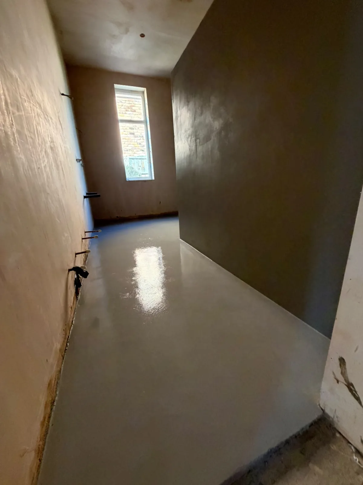 Microcement hallway floor and walls finished as one continuous surface