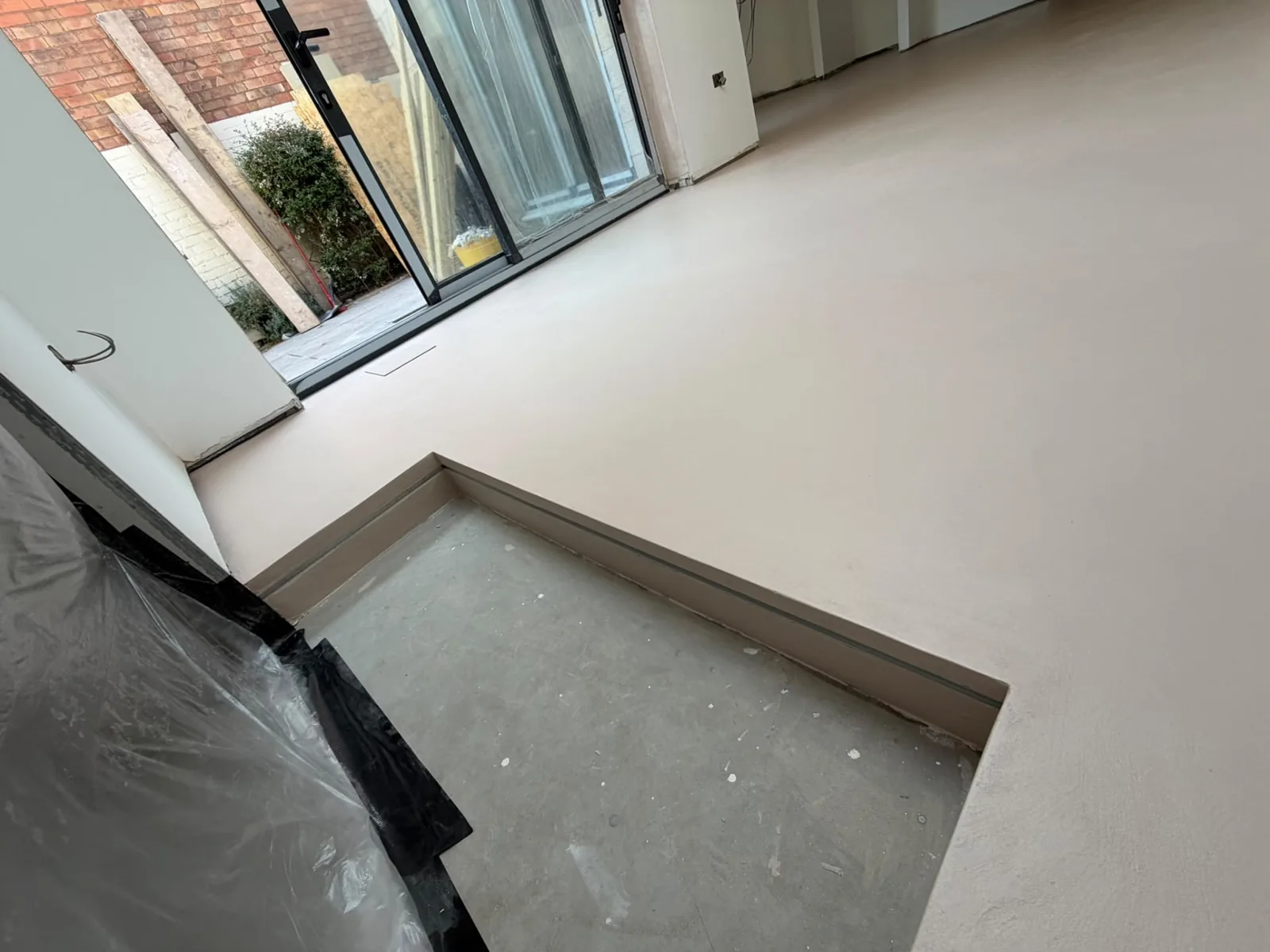 Microcement floor edge detail finished flush against a step