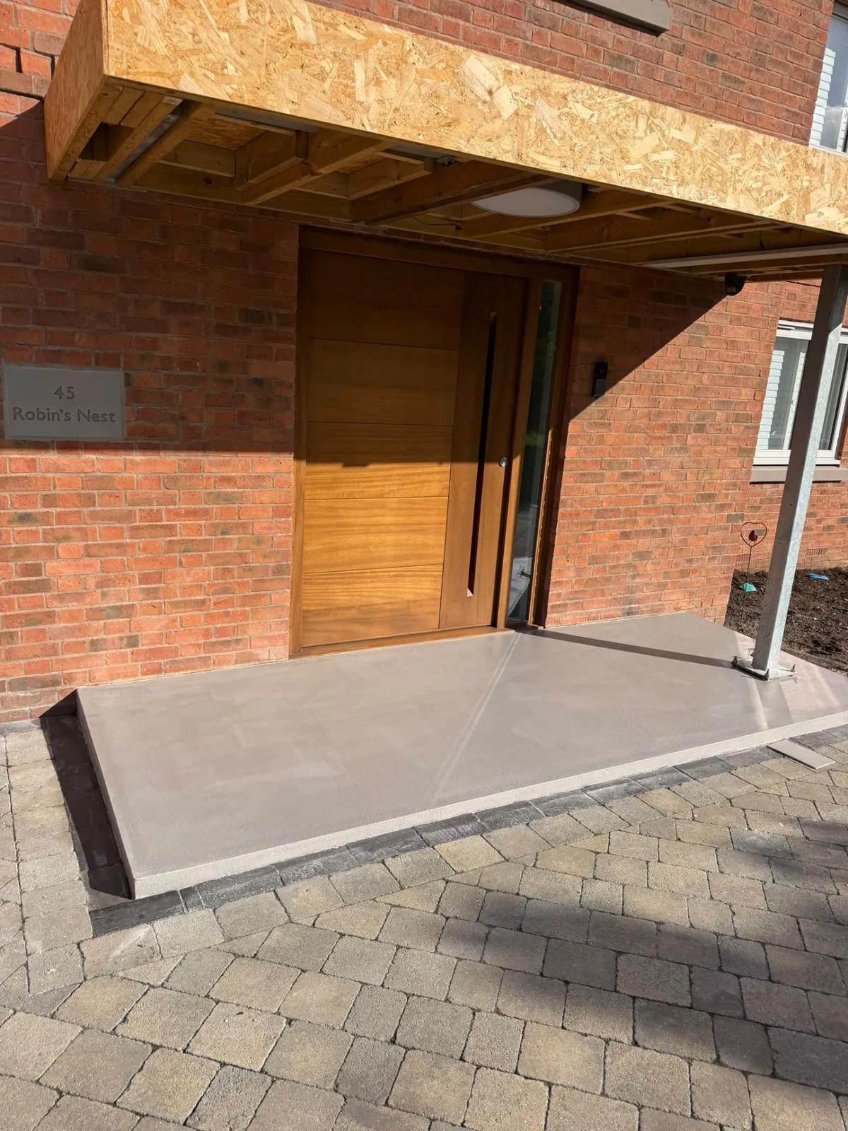 Microcement finish applied to an external porch surface