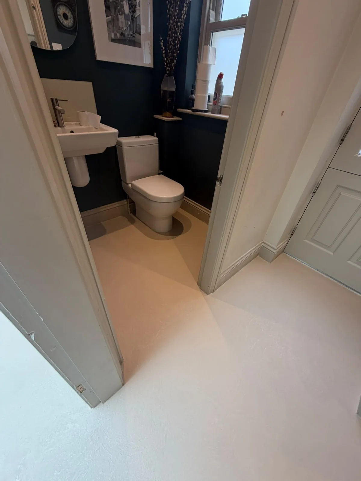 Microcement cloakroom floor continuing into the adjoining hallway
