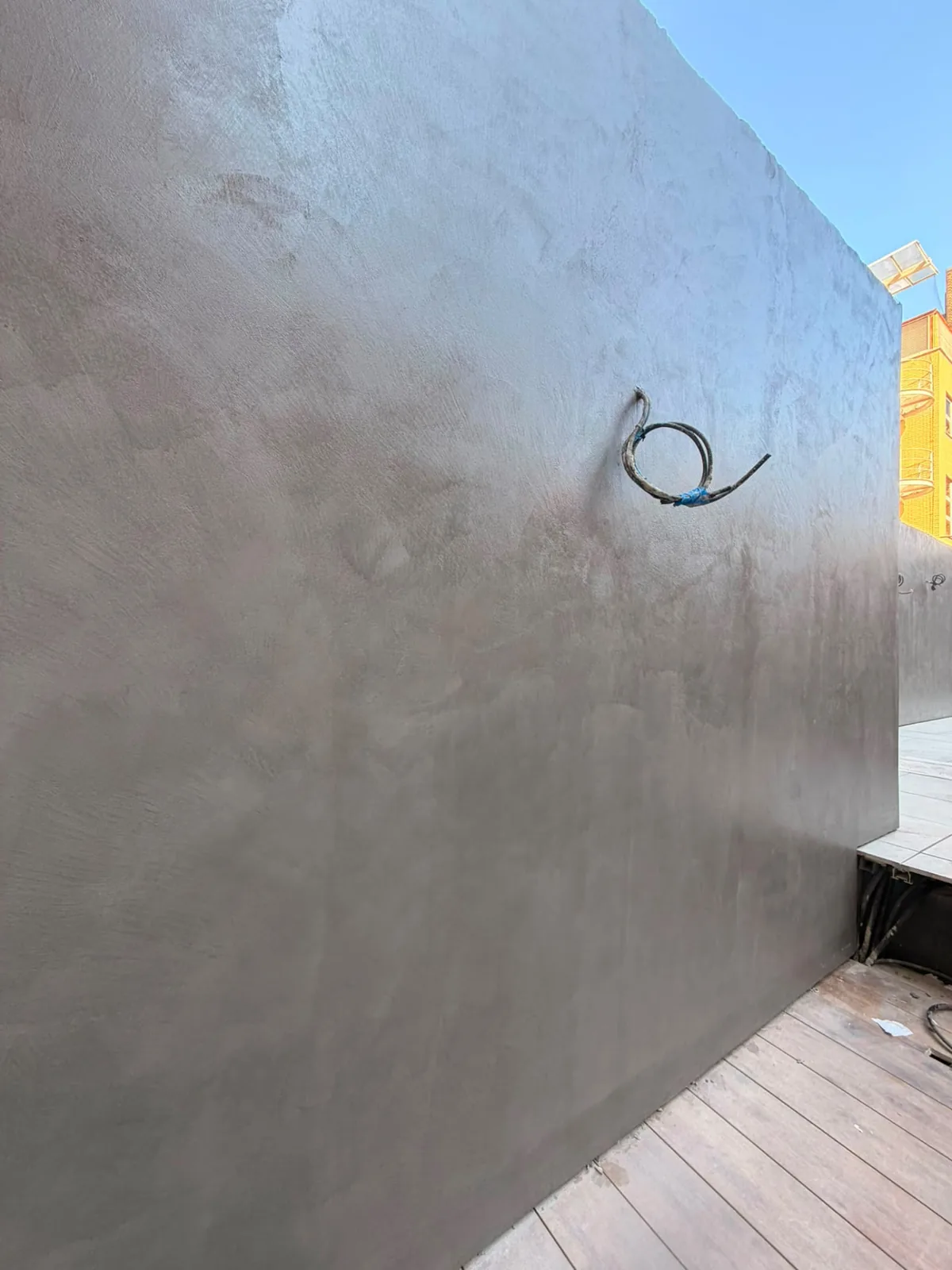 External microcement rendered wall finished in a neutral tone