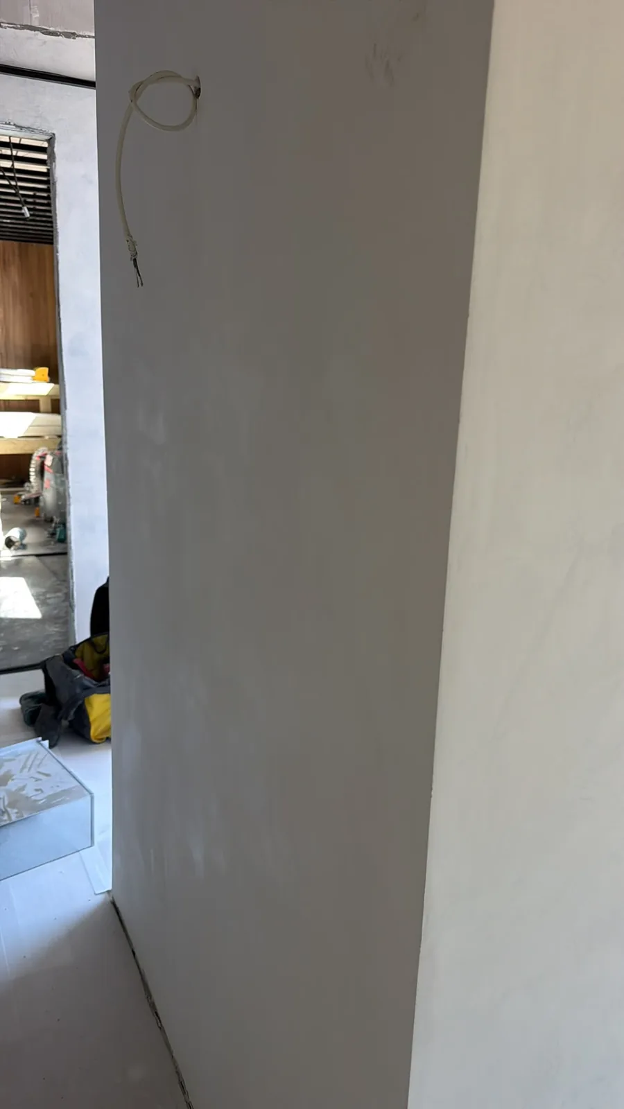 Grey microcement wall mid-installation in a Yorkshire property